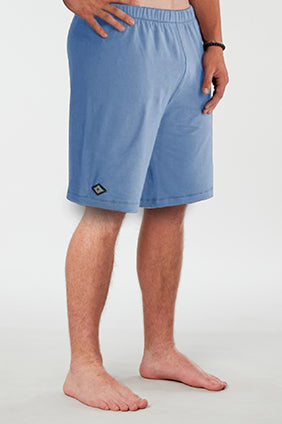 Front facing mans lower half of body wearing light blue colored organic cotton Mana yoga shorts