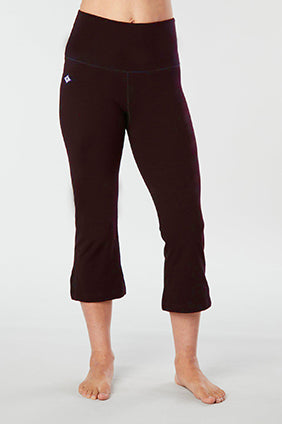 Woman's lower half facing forward of her body showing black colored organic cotton Moana Capri yoga pants