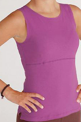 Woman torso facing forward with hands on hips wearing pink organic cotton Lani Top